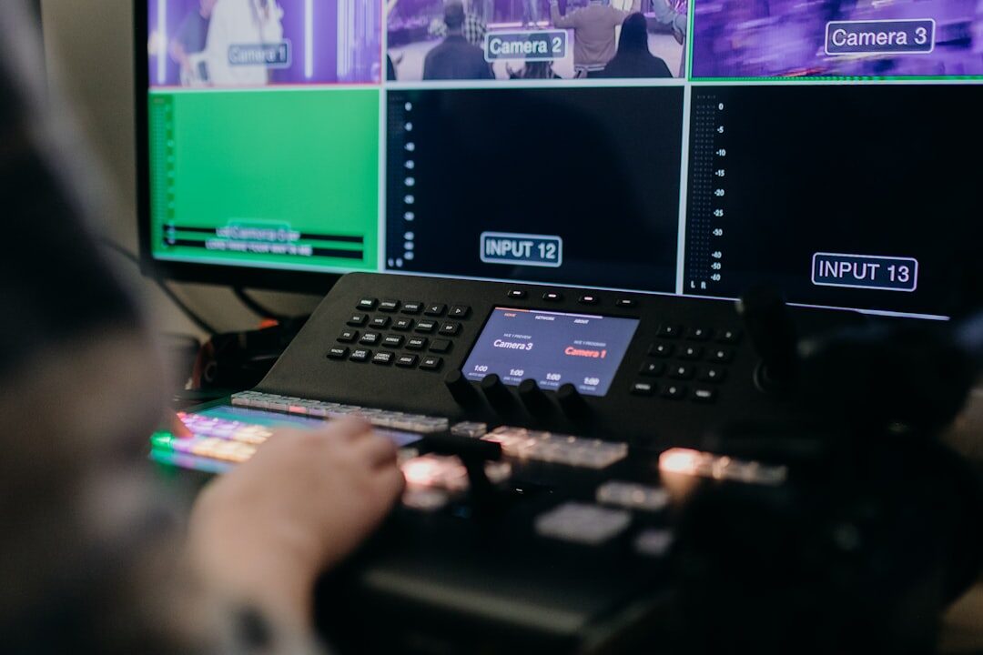 Broadcast control room with multiple video monitors and switching desk