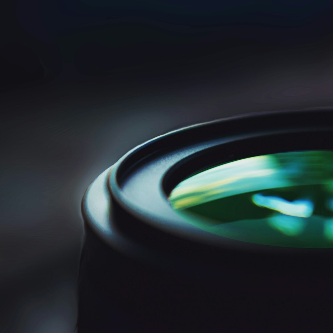 Close-up of a professional broadcast camera lens in a TV studio