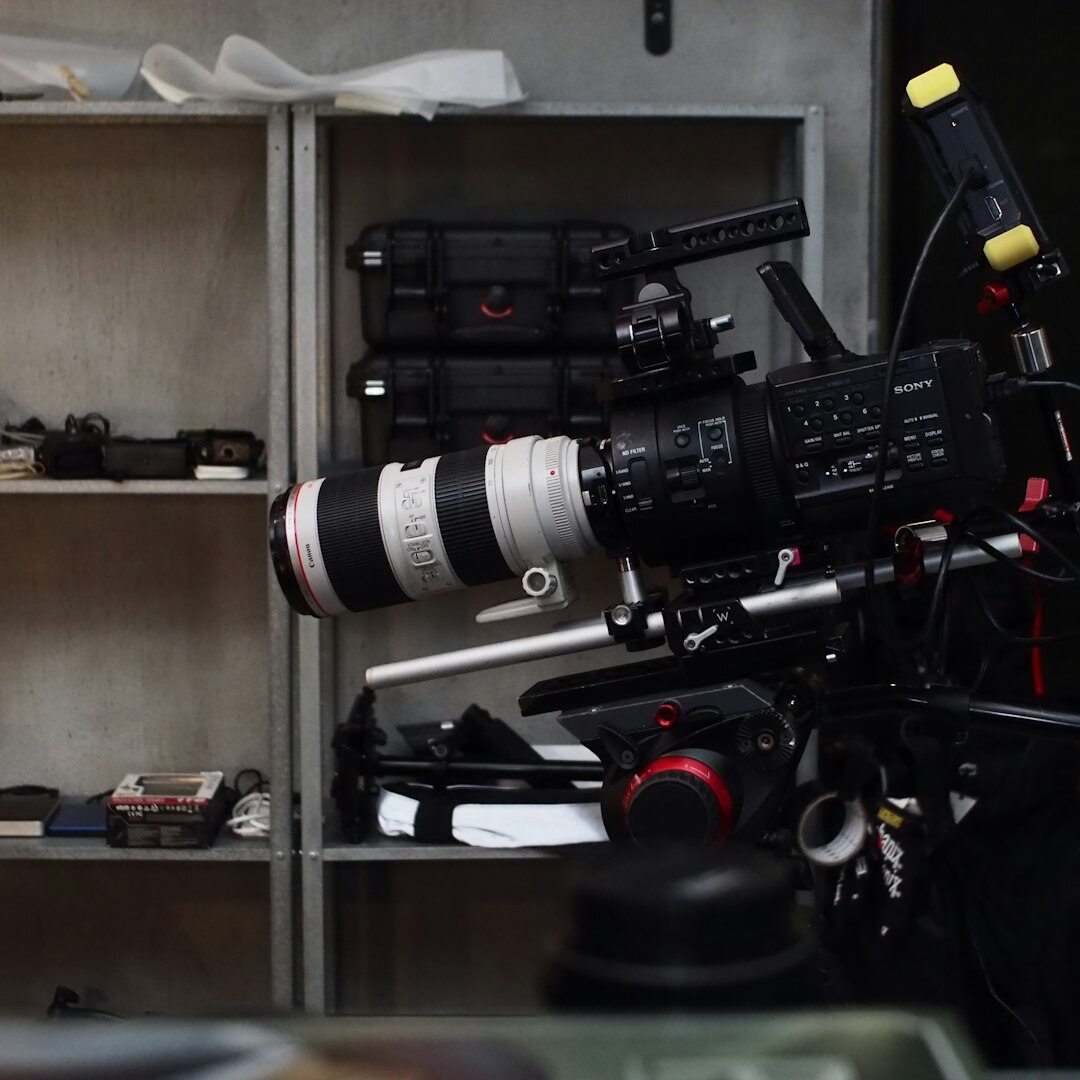Camera operator working a professional TV studio camera on a pedestal