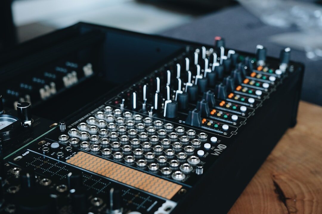 Audio mixing console with sliders and level meters in a sound studio
